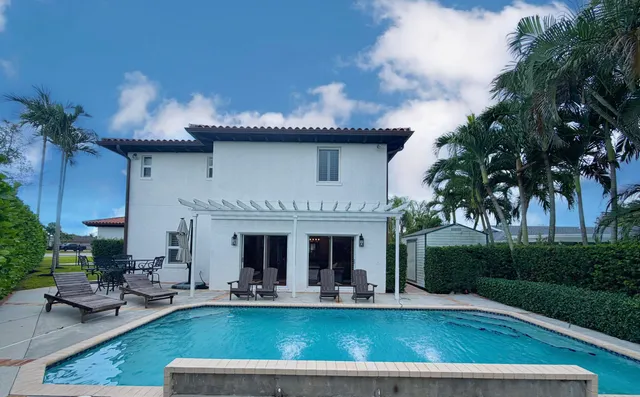 an aerial view of a house with a yard and swimming pool