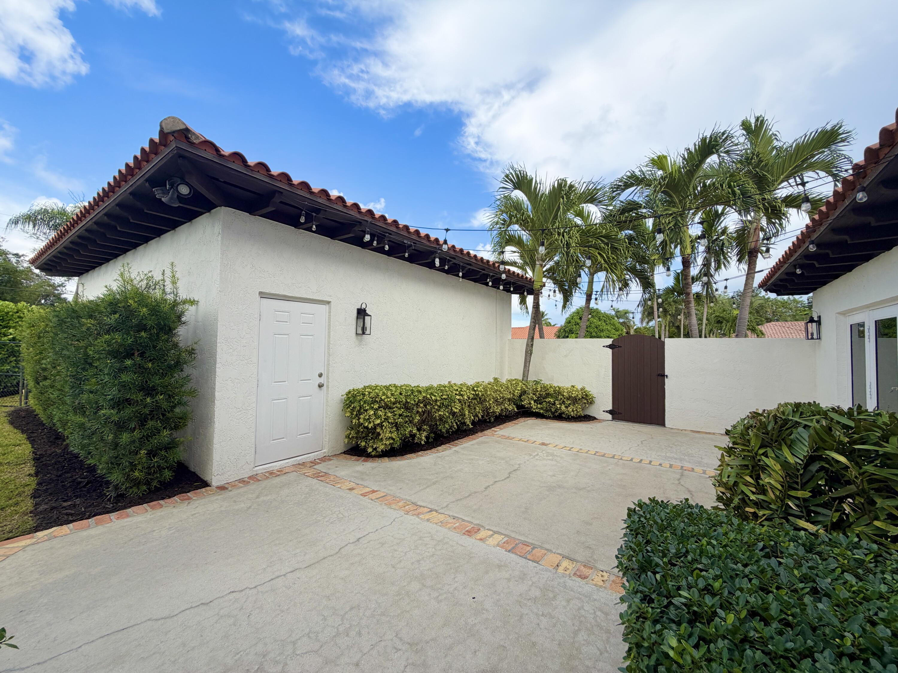6401 Travis Road West Palm Beach, FL 33406 - Photo 57 of 99 a front view of a house with a yard