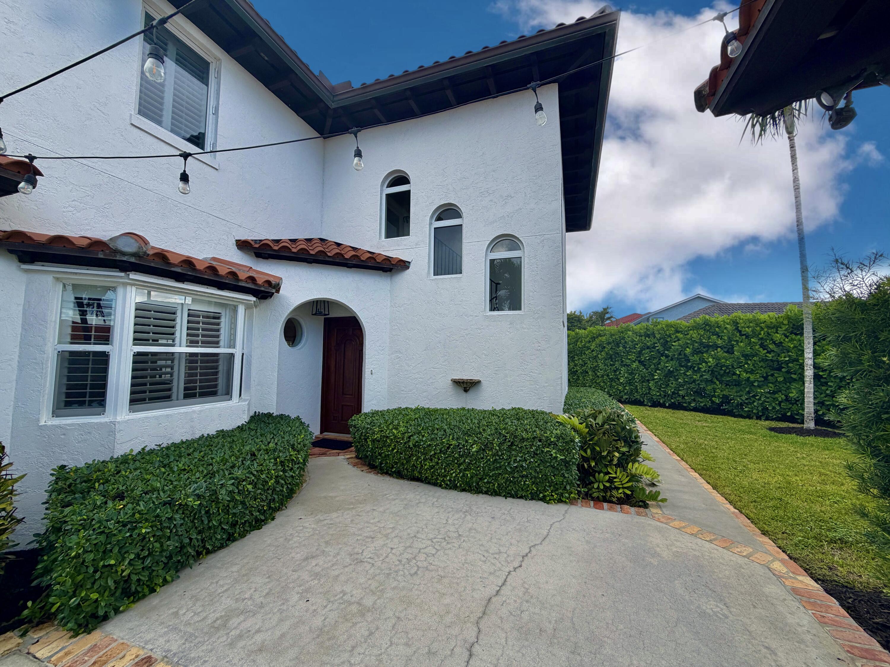 6401 Travis Road West Palm Beach, FL 33406 - Photo 58 of 99 a front view of a house with garden
