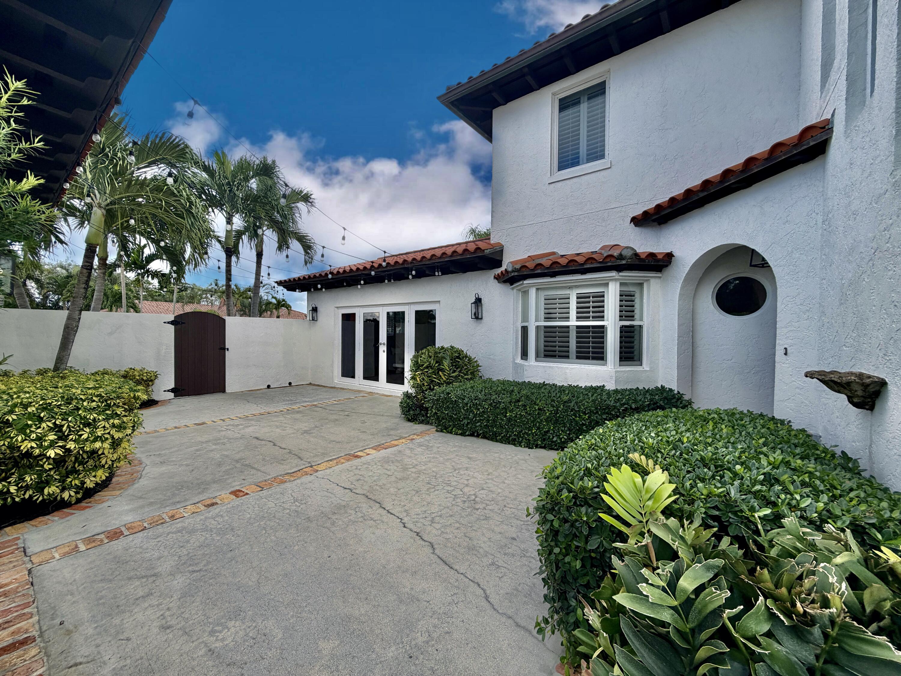 6401 Travis Road West Palm Beach, FL 33406 - Photo 60 of 99 a front view of a house with a yard
