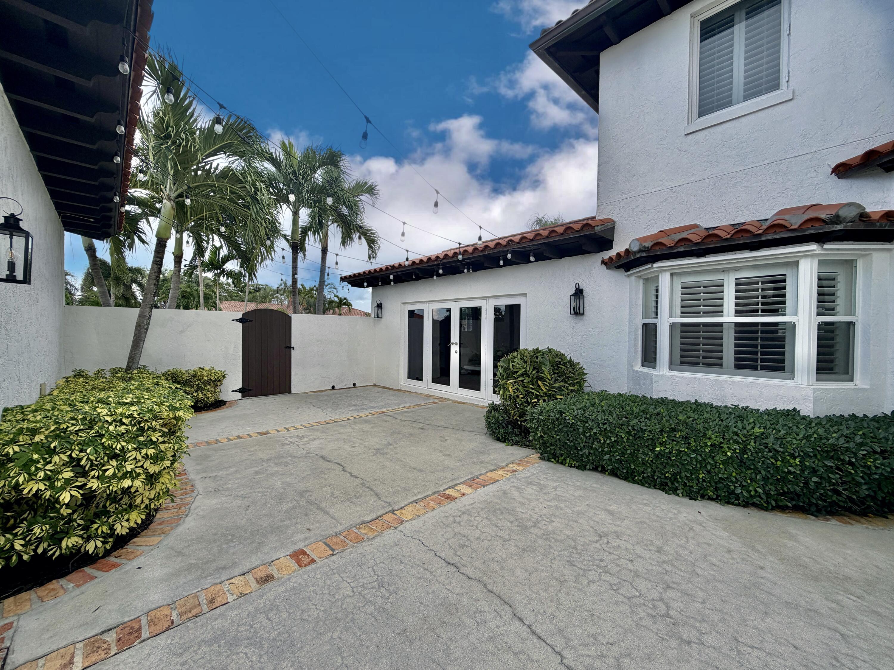6401 Travis Road West Palm Beach, FL 33406 - Photo 61 of 99 a front view of a house with a yard