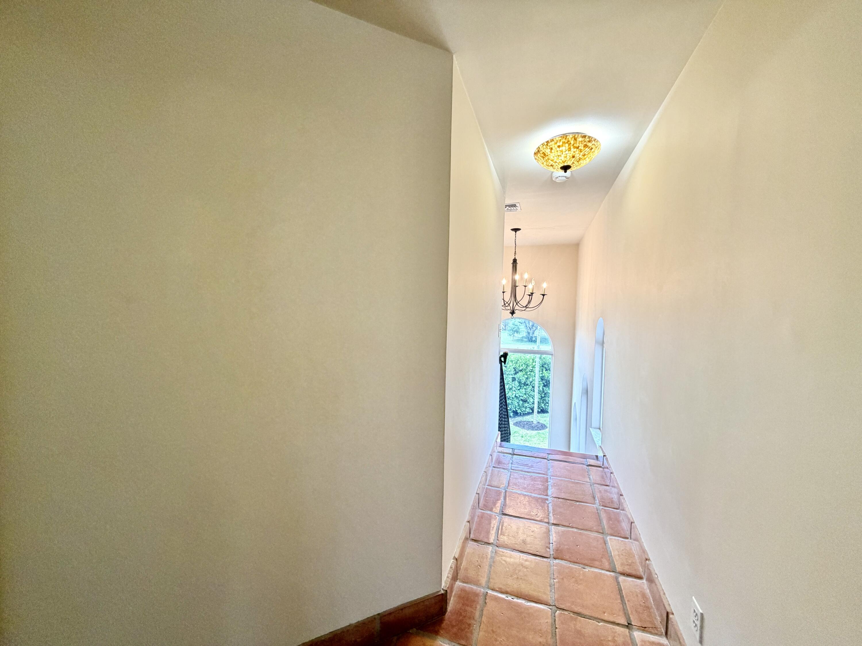 6401 Travis Road West Palm Beach, FL 33406 - Photo 62 of 99 a view of a hallway with window