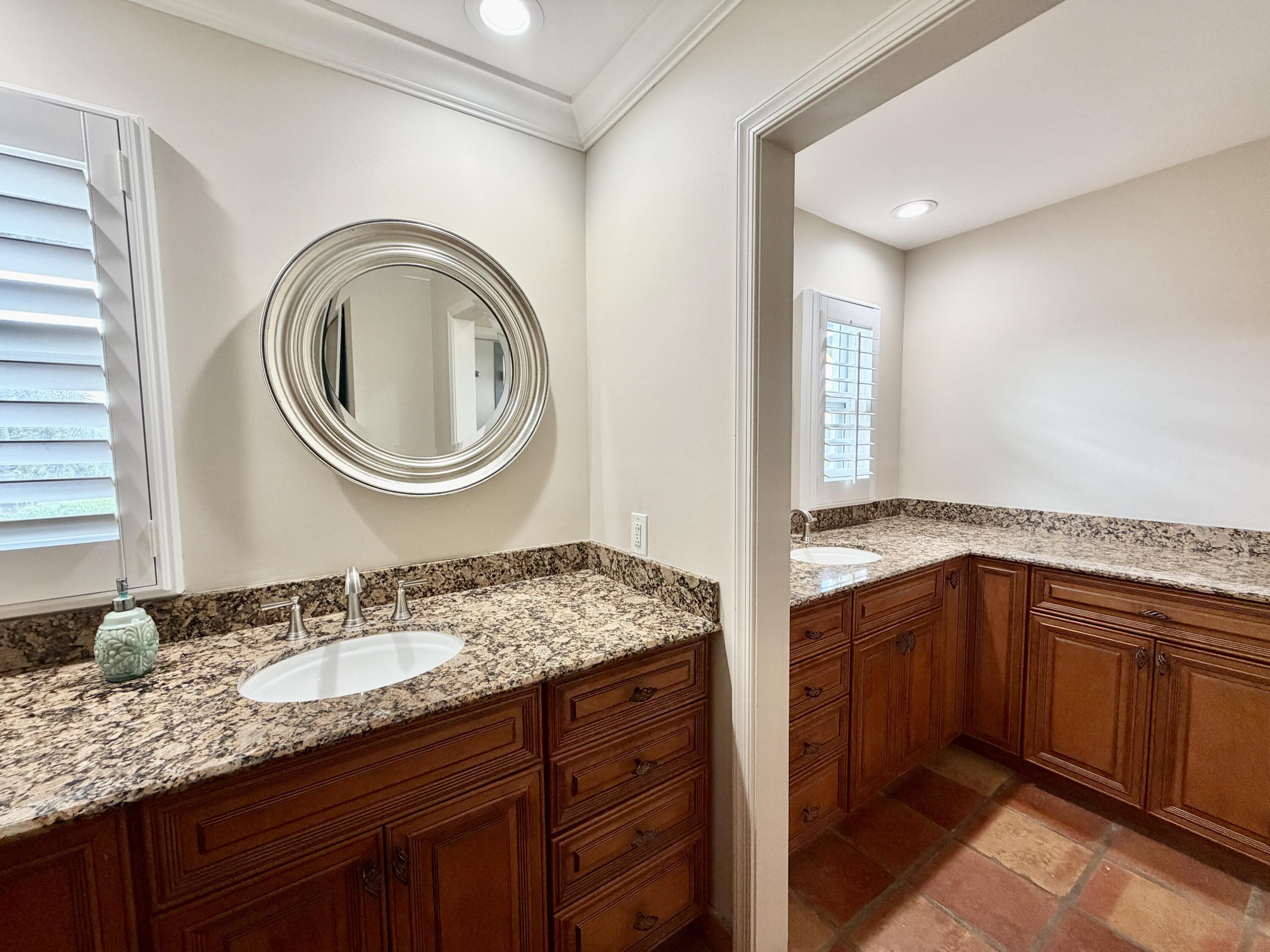 6401 Travis Road West Palm Beach, FL 33406 - Photo 69 of 99 a bathroom with a granite countertop double vanity sink and a mirror