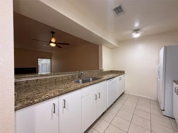 a kitchen with stainless steel appliances granite countertop a sink and a stove