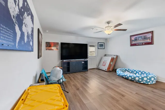 a living room with furniture and wooden floor
