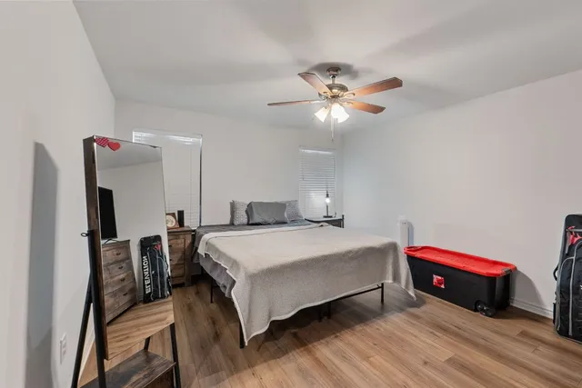 a bedroom with a bed and a chandelier