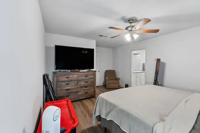 a bedroom with a bed and a flat screen tv