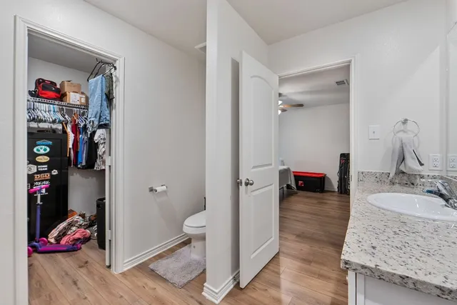 a bedroom with bed and a chandelier