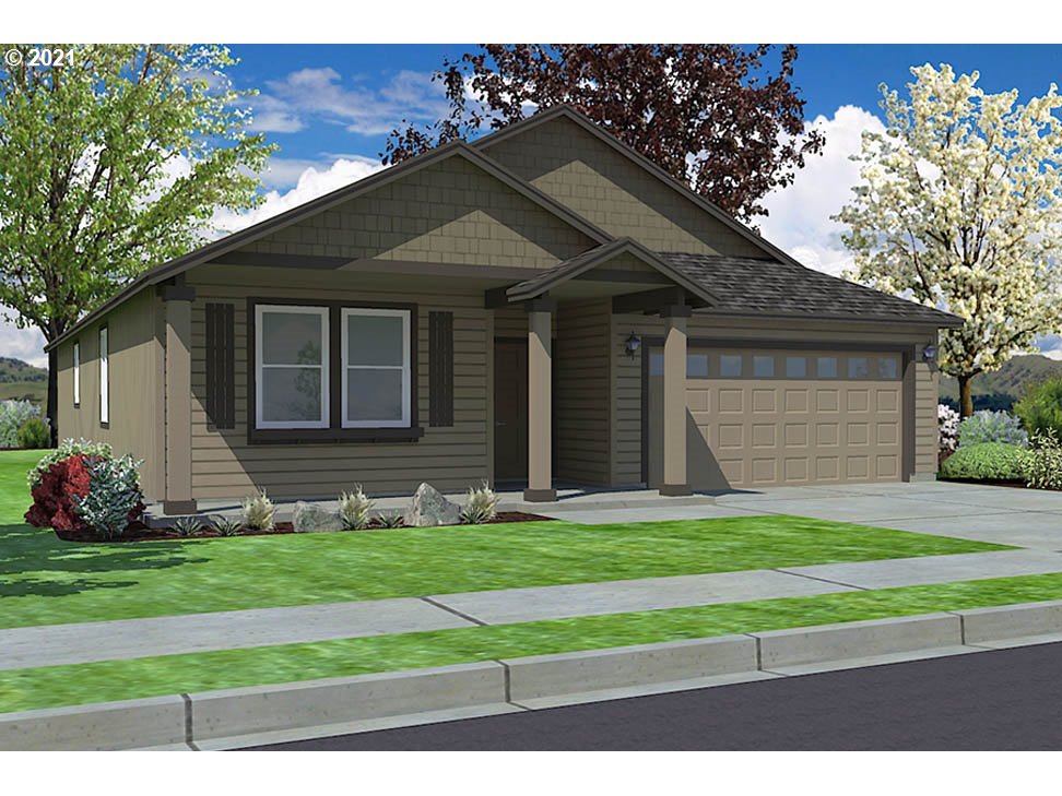 715 South 52nd Street Springfield, OR 97478 - Photo 2 of 11 a small white house with a yard plants and big trees