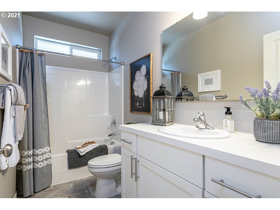 715 South 52nd Street Springfield, OR 97478 - Photo 10 of 11 a bathroom with a toilet sink double vanity and mirror