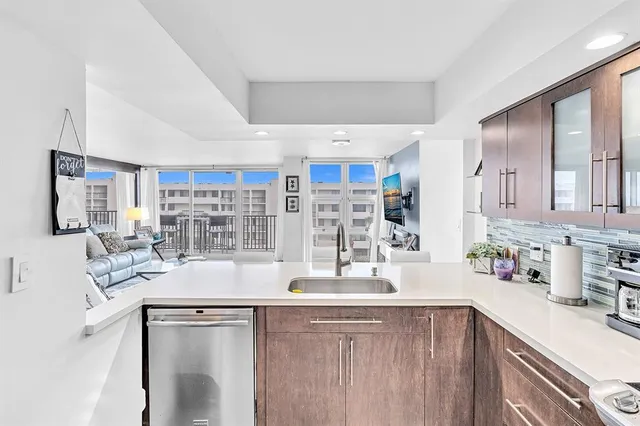 a living room with furniture floor to ceiling window and wooden floor