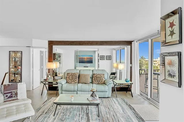 a view of a balcony with a floor to ceiling window and wooden floor