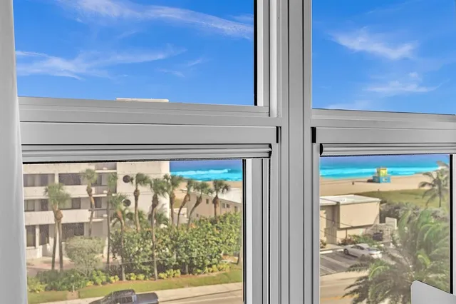 a view of a balcony with furniture and a ceiling fan