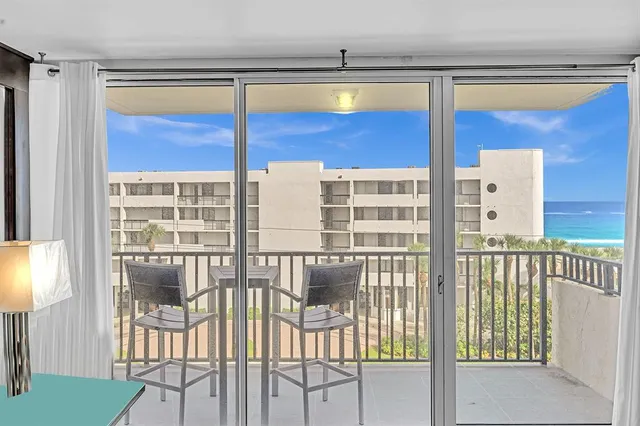 a living room with furniture and view of kitchen