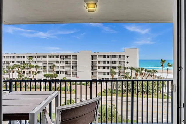 a dining hall with stainless steel appliances kitchen island granite countertop a dining table and chairs