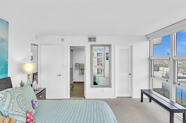 a kitchen with kitchen island granite countertop a sink cabinets and stainless steel appliances