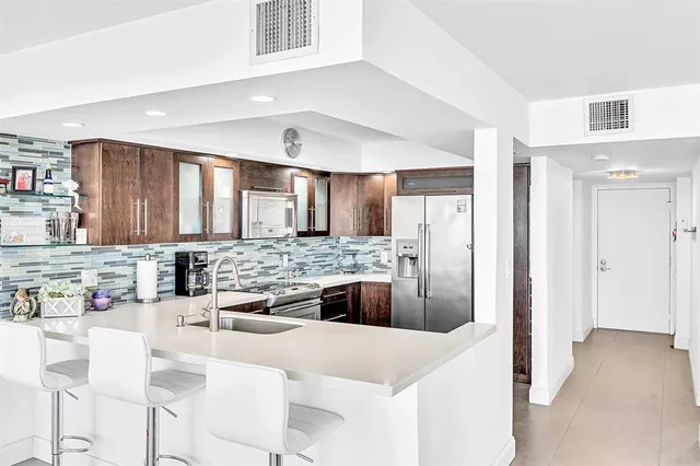 a view of a patio with couches table and chairs and potted plants