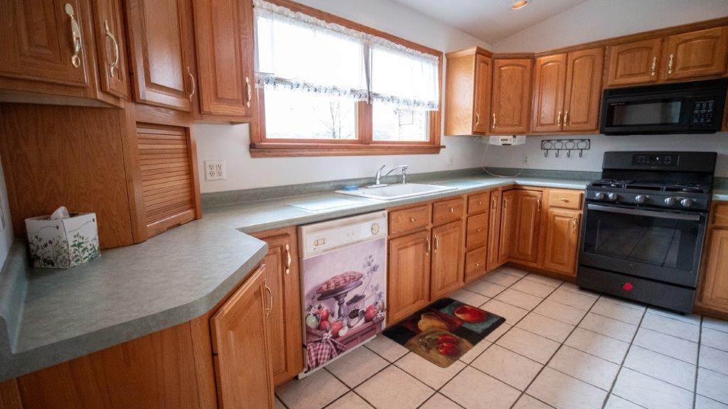 900 Lardintown Road Tarentum, PA 15084 - Photo 33 of 50 a kitchen with stainless steel appliances granite countertop a stove a sink and a microwave