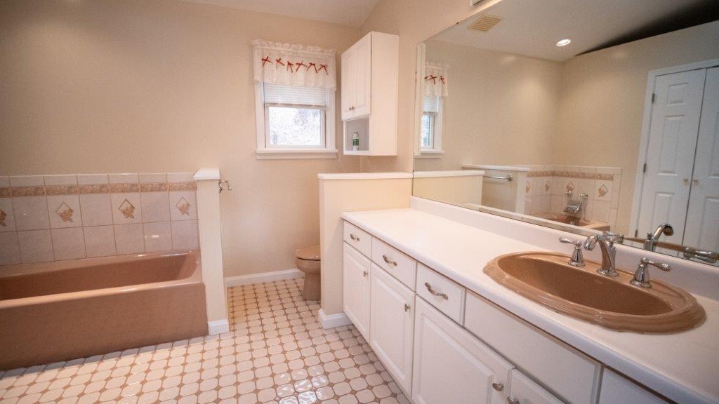 900 Lardintown Road Tarentum, PA 15084 - Photo 40 of 50 a bathroom with a granite countertop sink a mirror a bathtub and next to a window