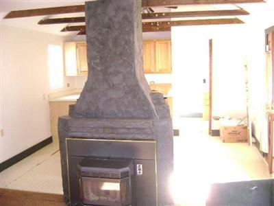 199 High Street Wareham, MA 02571 - Photo 5 of 6 a living room with a fireplace and a window