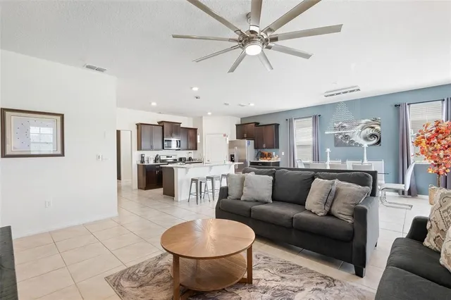 a living room with furniture and kitchen view