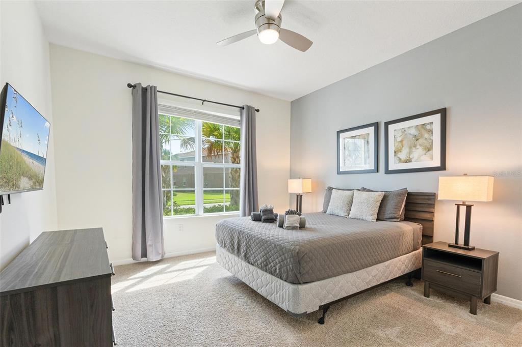7841 Oak Reflection Loop Davenport, FL 33837 - Photo 20 of 44 a spacious bedroom with a bed and a window