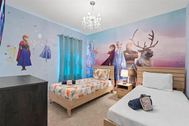 a bedroom with two beds and painting on the wall