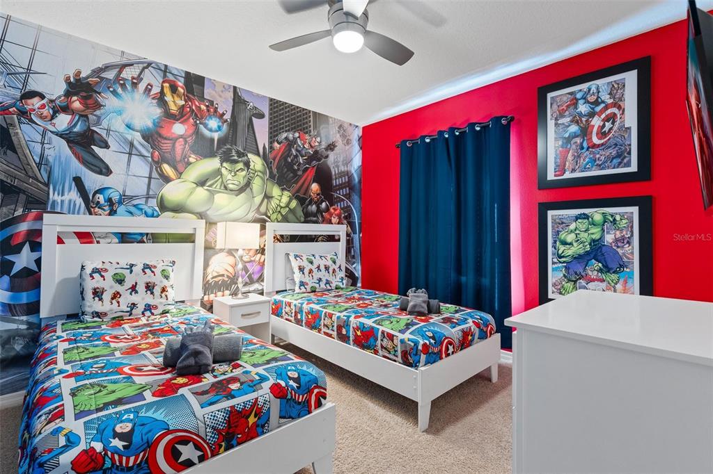 7841 Oak Reflection Loop Davenport, FL 33837 - Photo 31 of 44 a bedroom with a bed and a couch