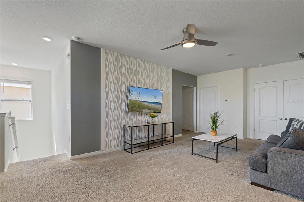 7841 Oak Reflection Loop Davenport, FL 33837 - Photo 33 of 44 a living room with furniture and a rug