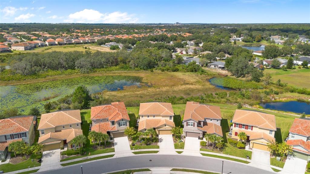 7841 Oak Reflection Loop Davenport, FL 33837 - Photo 4 of 44 an aerial view of residential houses with outdoor space and river