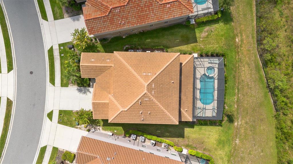 7841 Oak Reflection Loop Davenport, FL 33837 - Photo 43 of 44 an aerial view of a house with swimming pool and large trees