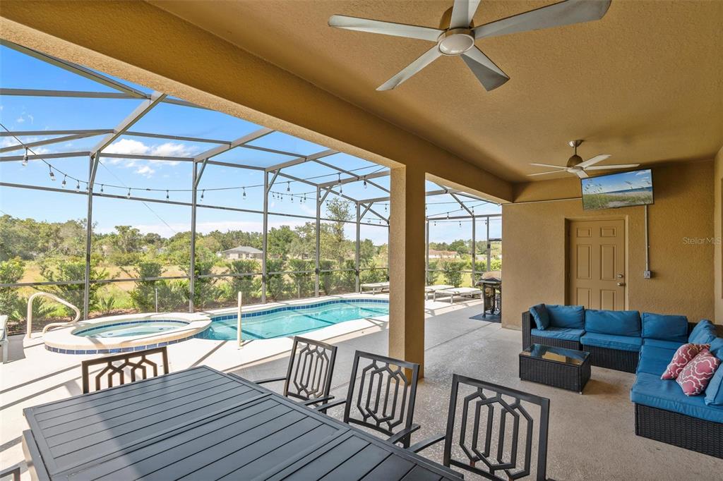 7841 Oak Reflection Loop Davenport, FL 33837 - Photo 6 of 44 a living room with furniture and a floor to ceiling window