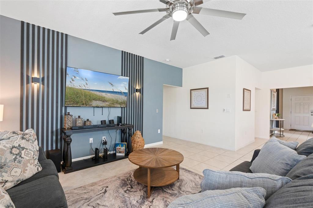 7841 Oak Reflection Loop Davenport, FL 33837 - Photo 8 of 44 a living room with furniture and a large window