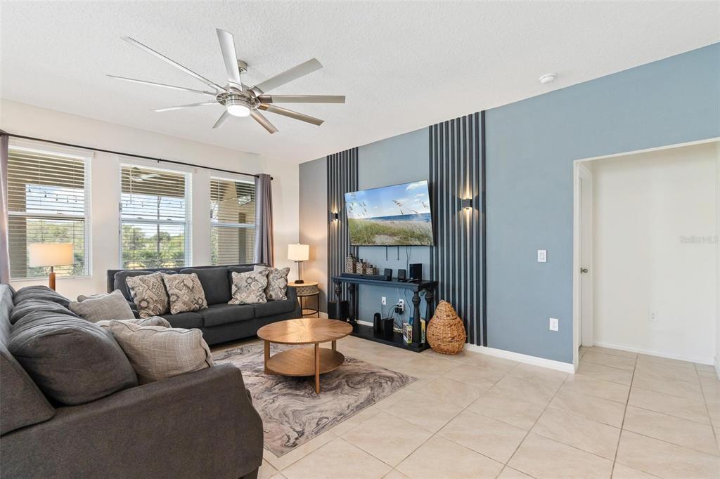 7841 Oak Reflection Loop Davenport, FL 33837 - Photo 9 of 44 a living room with furniture a chandelier and a window