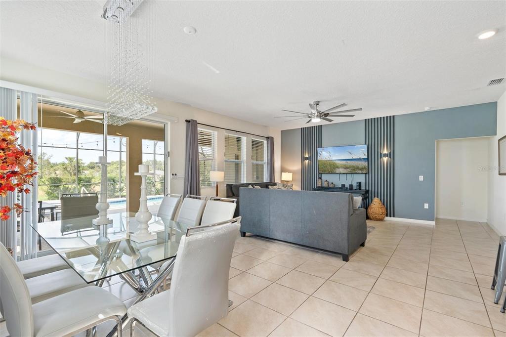 7841 Oak Reflection Loop Davenport, FL 33837 - Photo 10 of 44 a living room with furniture and a flat screen tv