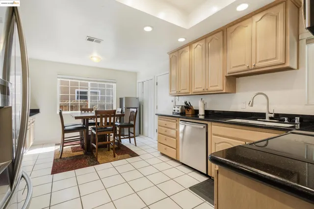 a bed sitting in a bedroom next to a window with dresser