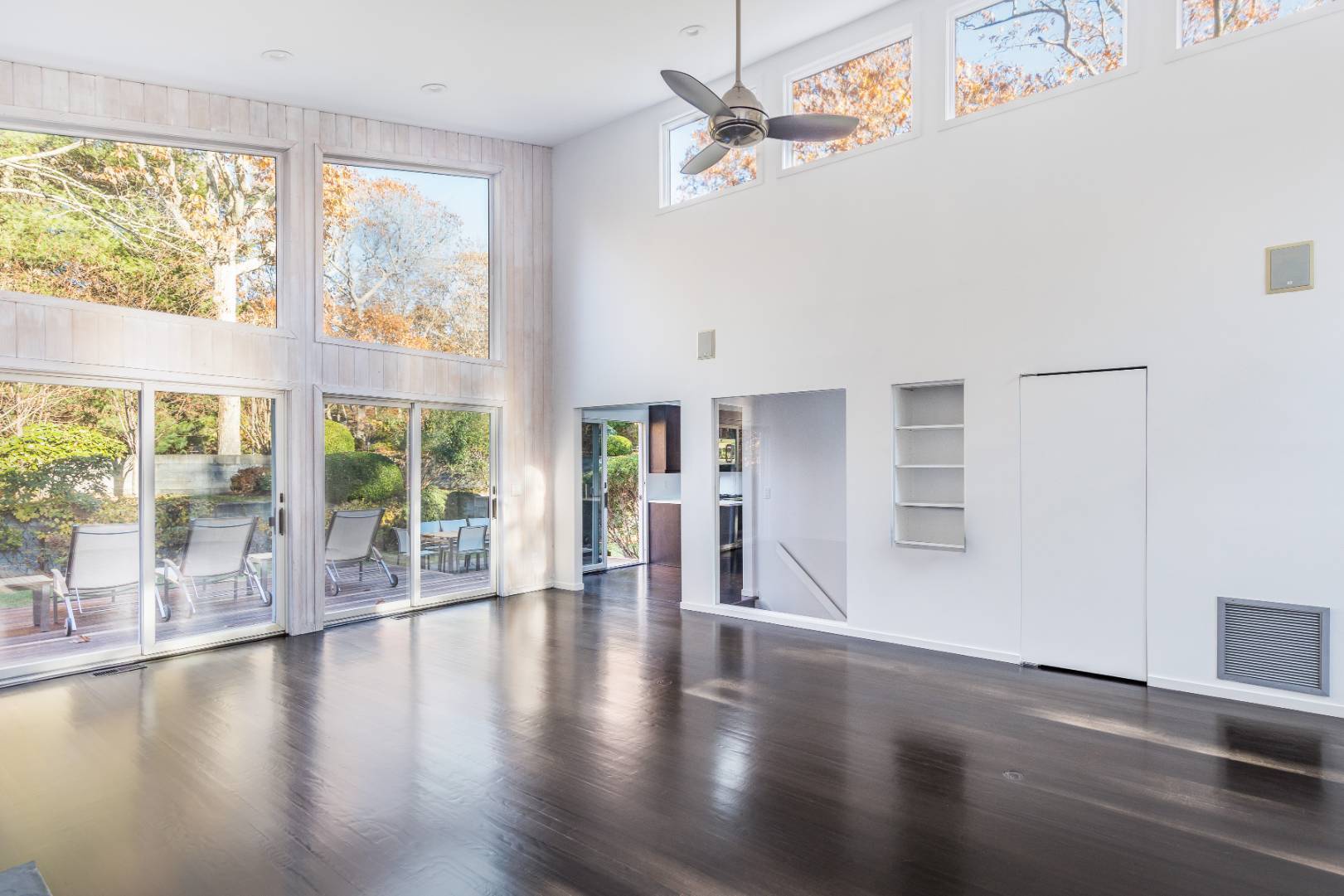 132 Springy Banks Road East Hampton, NY 11937 - Photo 11 of 37 a view of an empty room with wooden floor and a window