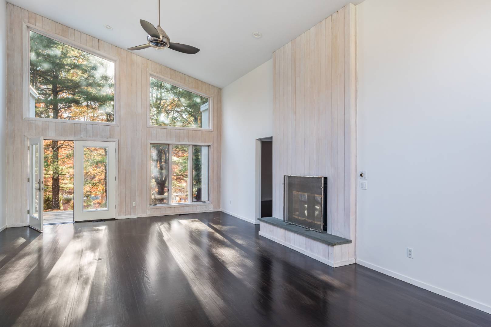 132 Springy Banks Road East Hampton, NY 11937 - Photo 12 of 37 a view of an empty room with wooden floor and a window