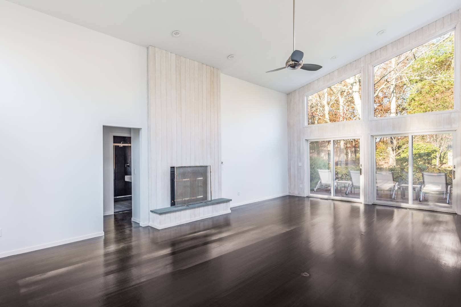 132 Springy Banks Road East Hampton, NY 11937 - Photo 13 of 37 a view of an empty room with wooden floor and a window