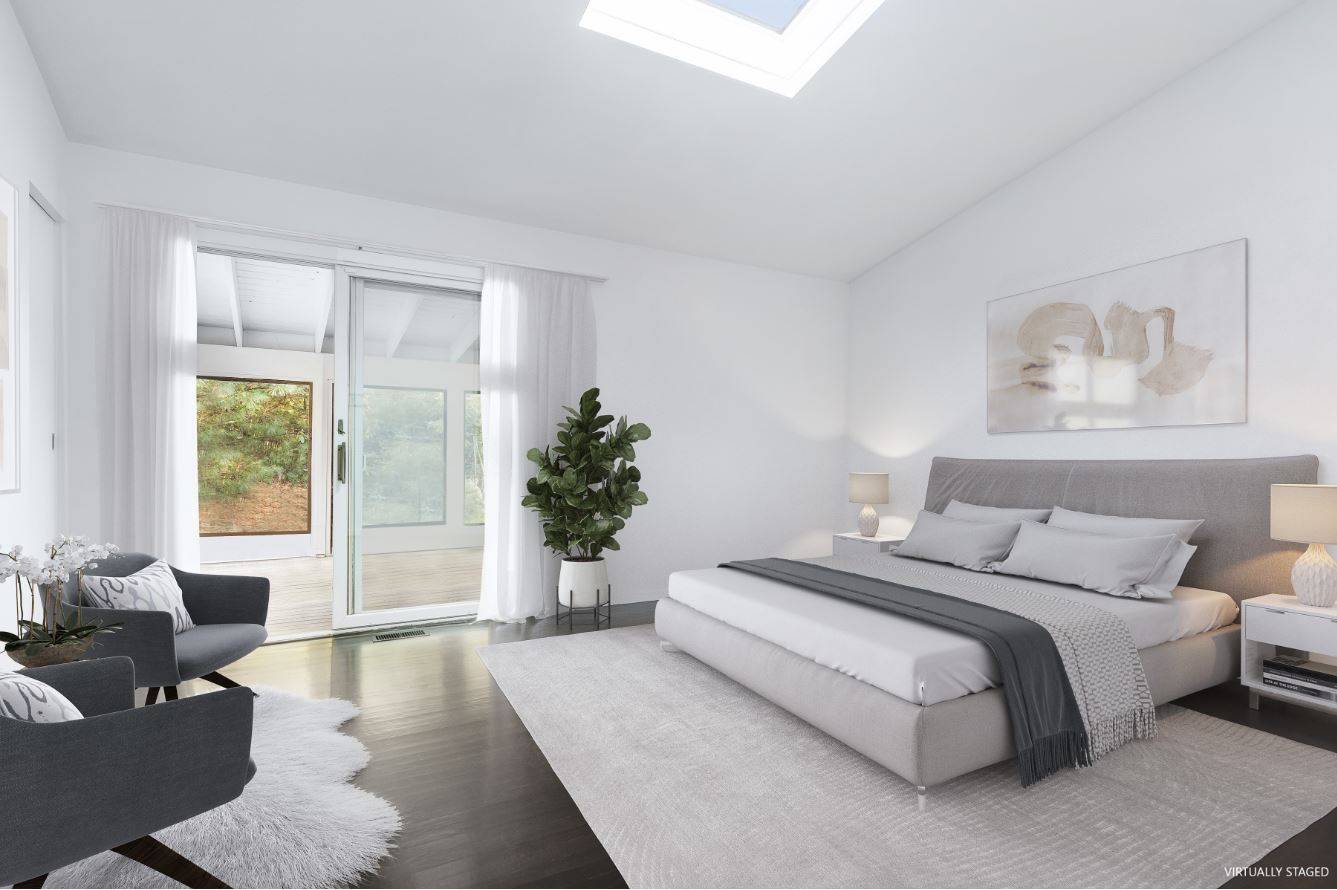 132 Springy Banks Road East Hampton, NY 11937 - Photo 18 of 37 a spacious bedroom with a large bed and a couch