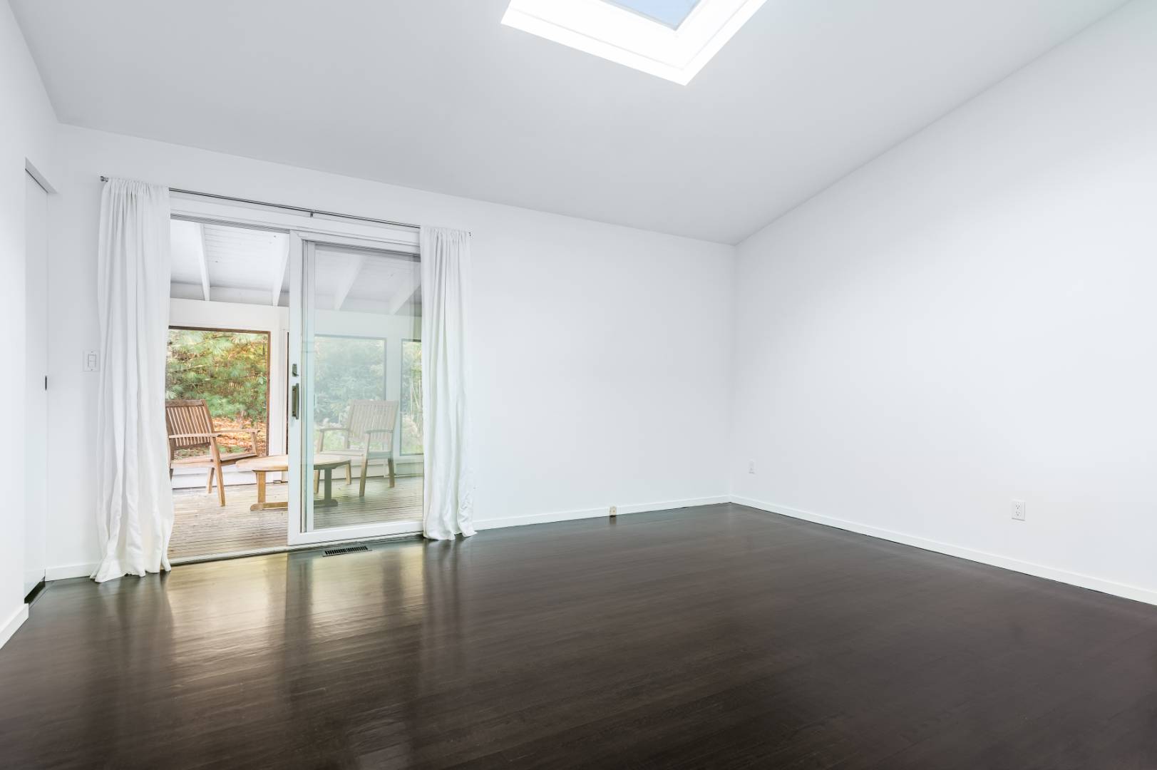 132 Springy Banks Road East Hampton, NY 11937 - Photo 19 of 37 a view of an empty room with wooden floor and a window