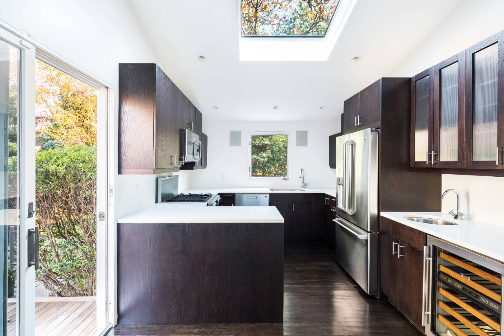 132 Springy Banks Road East Hampton, NY 11937 - Photo 9 of 37 a kitchen with stainless steel appliances a sink cabinets and wooden floor