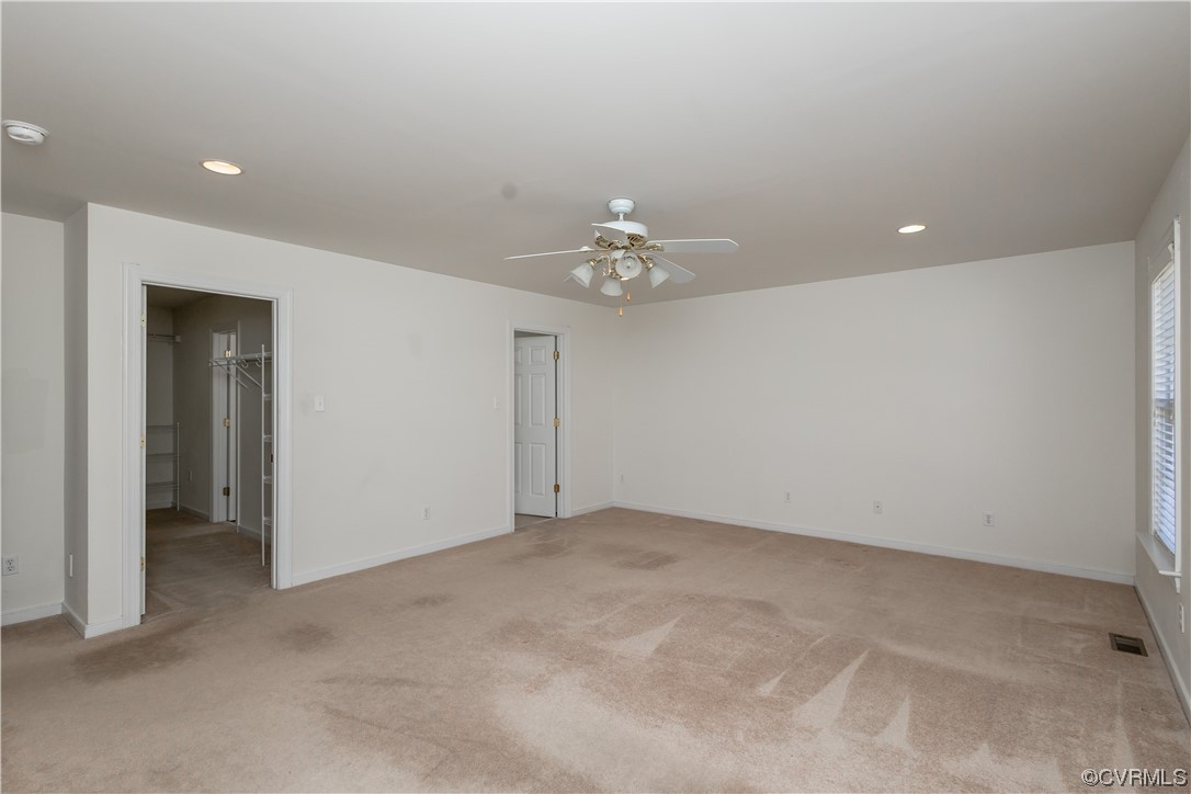 13003 Chipstead Road Chester, VA 23831 - Photo 7 of 38 an empty room with a chandelier fan and closet area