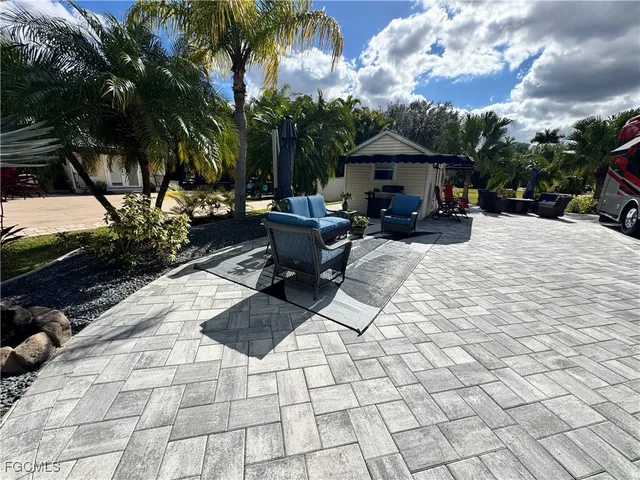 a view of house with backyard and outdoor seating