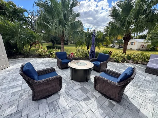 a view of a patio with couches and a fire pit