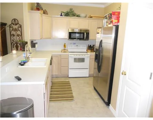 a kitchen with a refrigerator sink and a stove