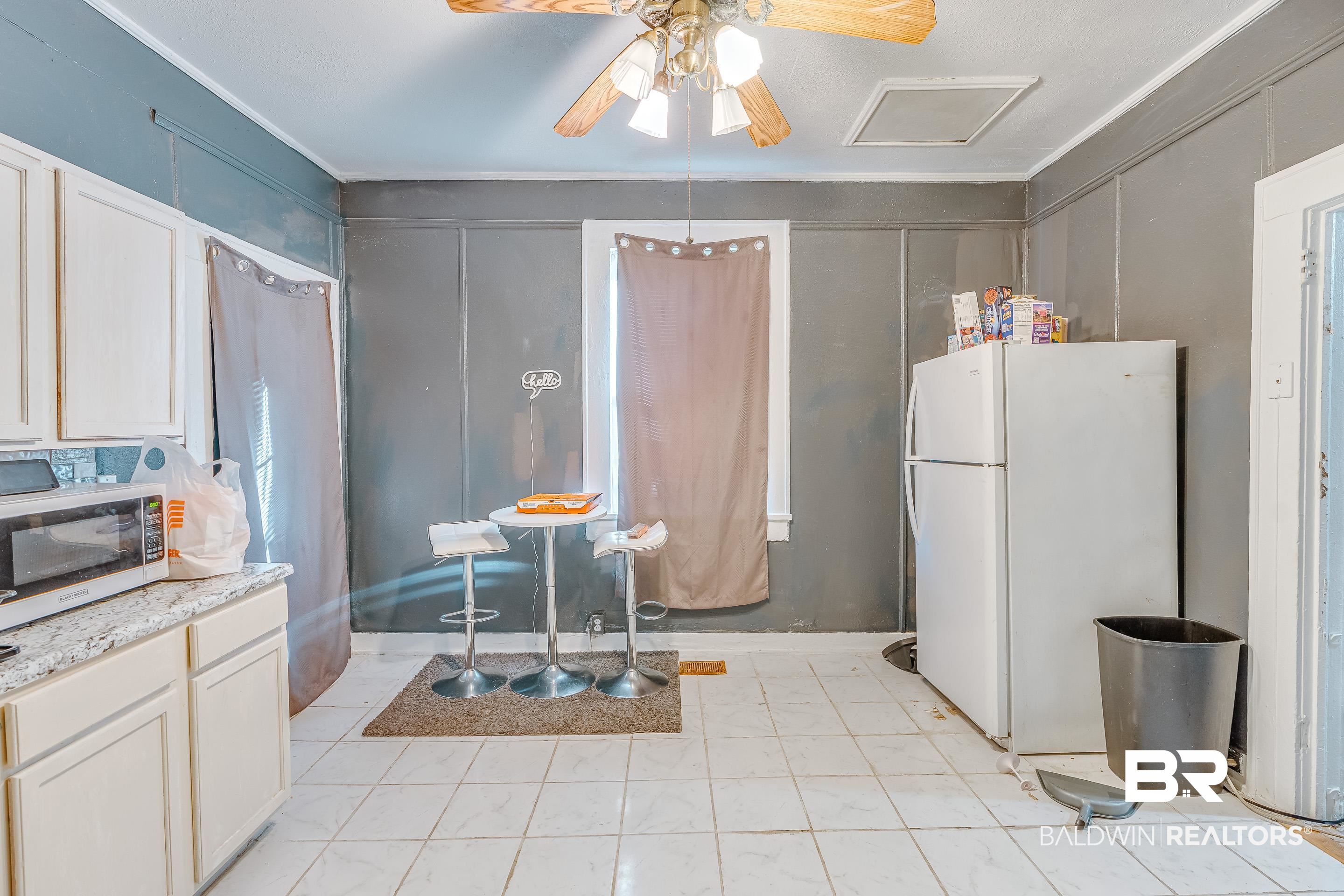 14 Southern Street Mobile, AL 36611 - Photo 8 of 26 Kitchen with white refrigerator, ceiling fan, ornamental molding, and white cabinets