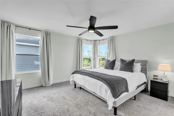 a spacious bedroom with a bed and a window