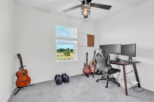 a view of a workspace with furniture and a window