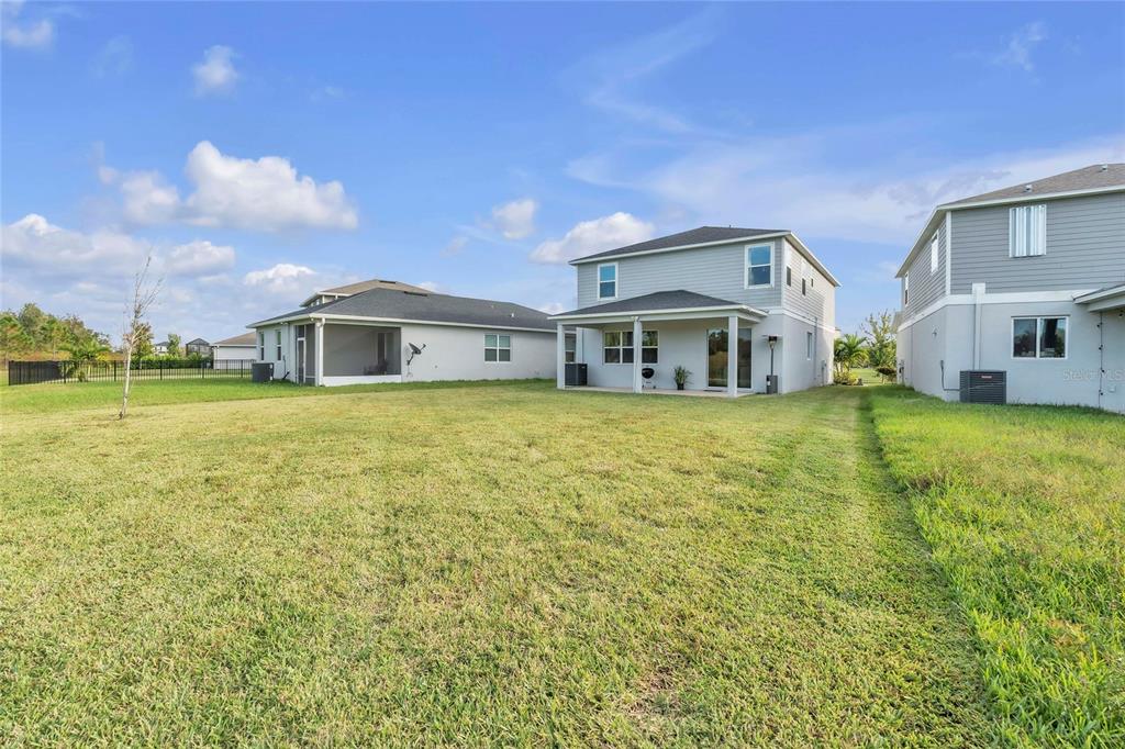 11512 Gallatin Trail Parrish, FL 34219 - Photo 29 of 39 a view of a house with a big yard and large trees
